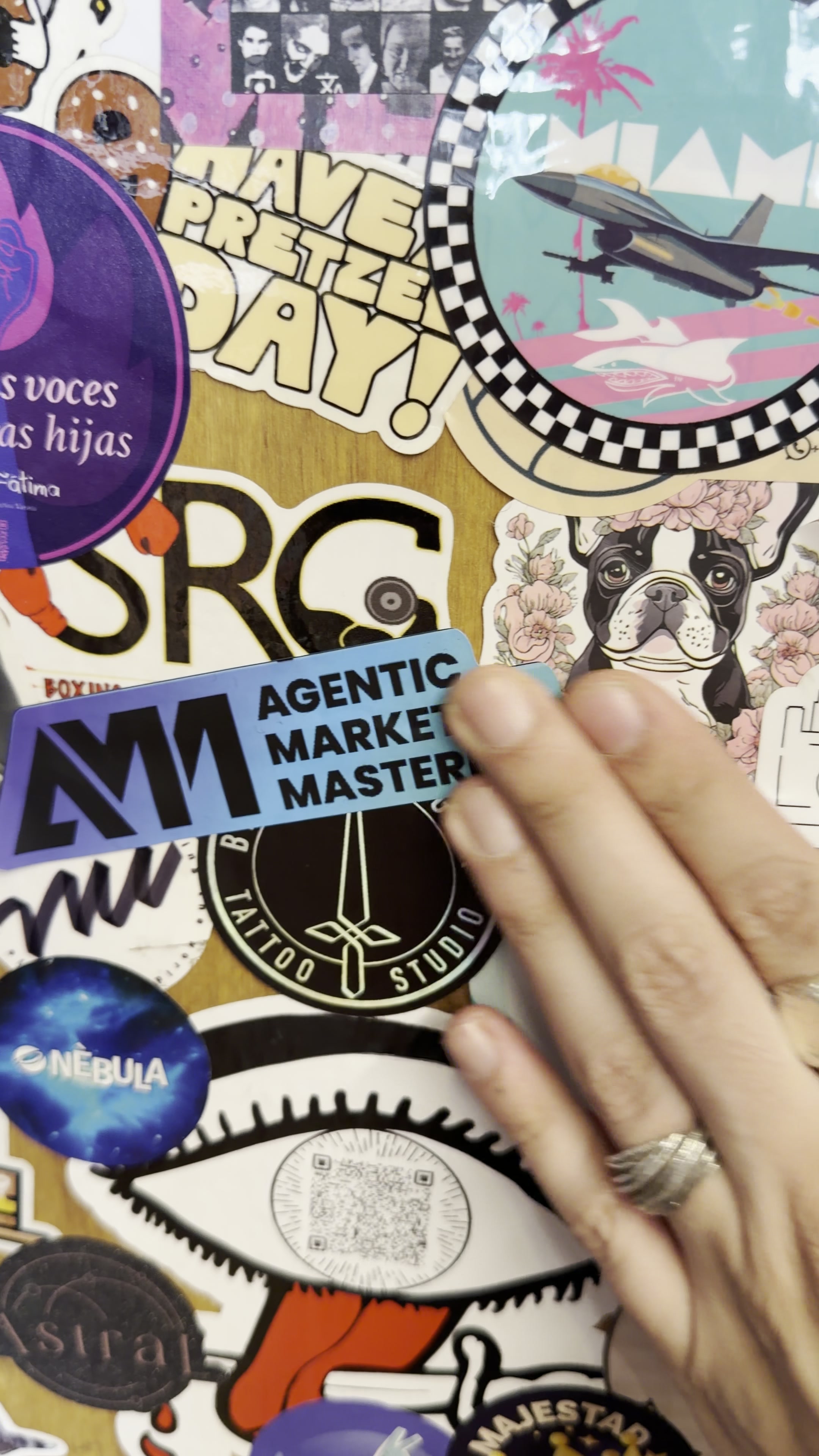 Placing an Agentic Marketing Mastermind sticker on a community wall